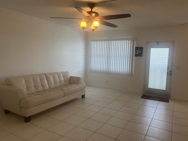 4034 Exeter Unit B, Boca Raton, FL 33434 - living room with healthy amount of natural light, light tile patterned floors, a textured ceiling, and baseboards