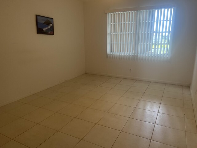 4034 Exeter Unit B, Boca Raton, FL 33434 - tiled empty room with baseboards