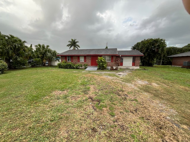 view of front facade with a garage and a front lawn