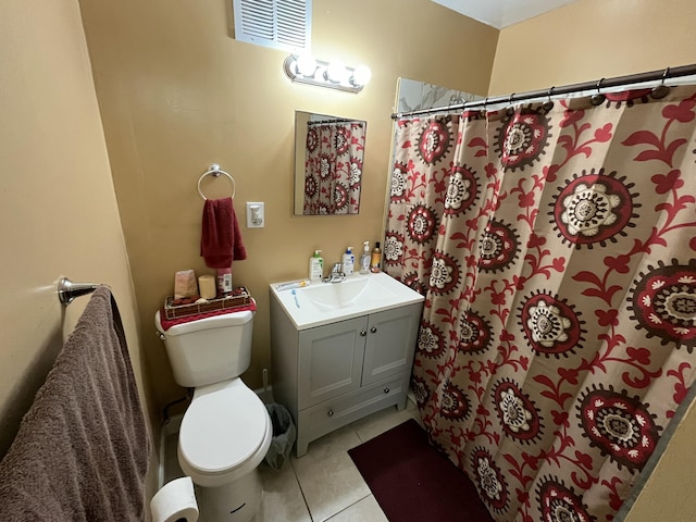 bathroom featuring vanity, walk in shower, tile patterned floors, and toilet