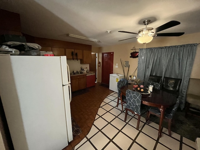 kitchen featuring sink, stainless steel dishwasher, ceiling fan, and white refrigerator