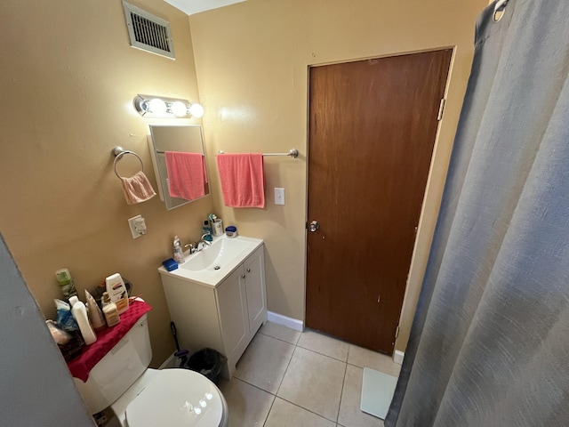 bathroom with vanity, tile patterned floors, and toilet