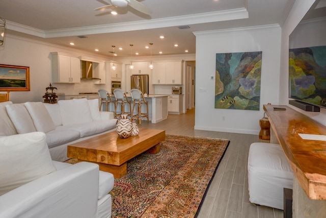 living room with recessed lighting, visible vents, ornamental molding, ceiling fan, and light wood-type flooring