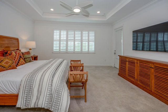 bedroom with recessed lighting, a tray ceiling, ornamental molding, and light colored carpet