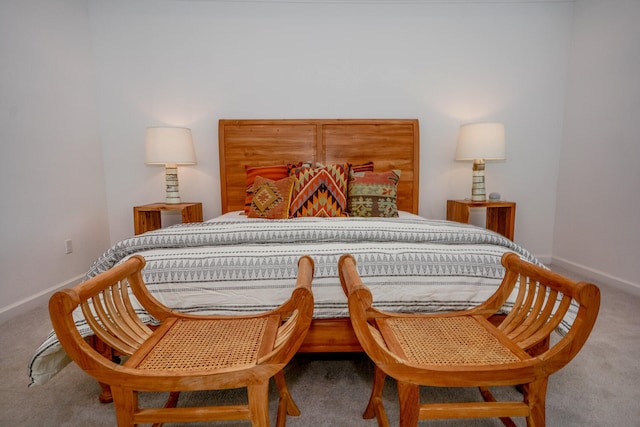 bedroom featuring carpet and baseboards