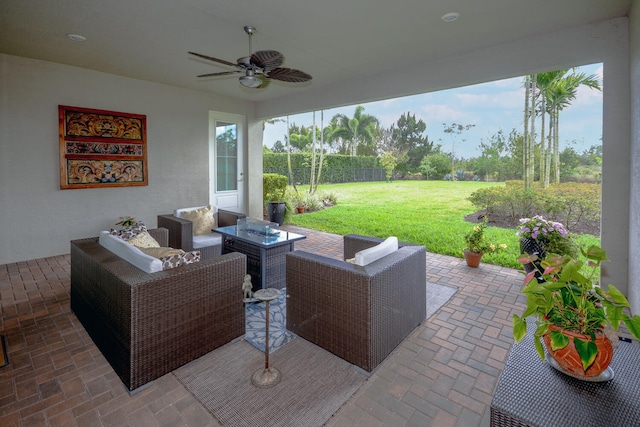 view of patio / terrace with fence, an outdoor living space, and a ceiling fan