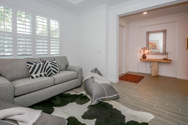 living room featuring wood tiled floor, ornamental molding, and baseboards