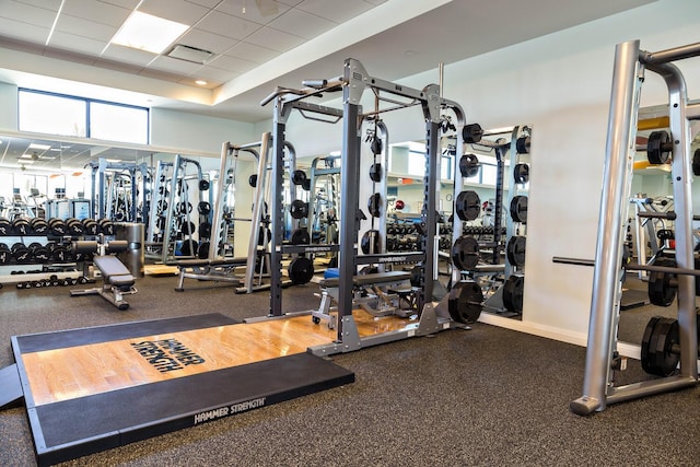 gym with visible vents and a paneled ceiling