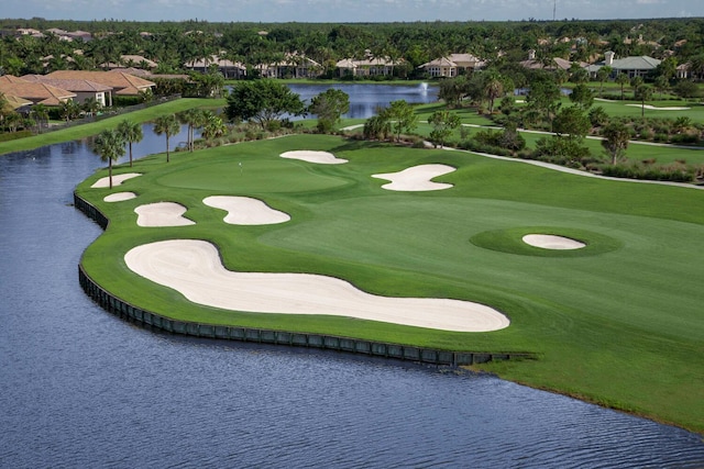 view of home's community with a water view and golf course view