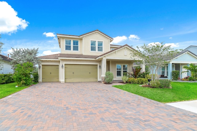 view of front of house with a garage and a front yard