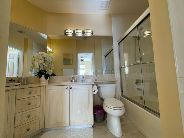 663 Hibiscus St, West Palm Beach, FL 33401 - full bathroom with vanity, tile patterned flooring, bath / shower combo with glass door, and toilet