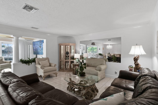 tiled living room with decorative columns, a textured ceiling, and a notable chandelier