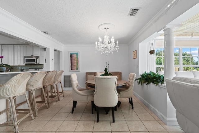 tiled dining space with crown molding, a chandelier, and a textured ceiling