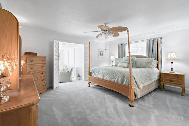 bedroom with crown molding, ceiling fan, carpet, and a textured ceiling