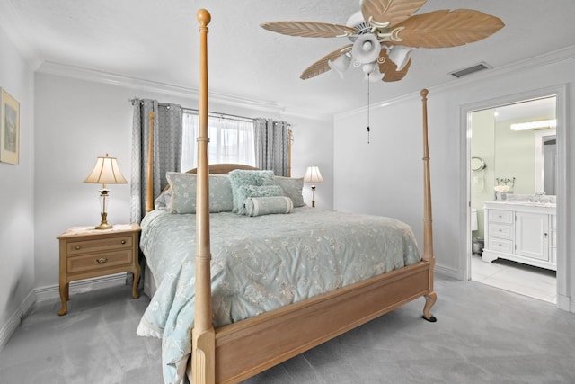 bedroom with crown molding, connected bathroom, sink, and light carpet