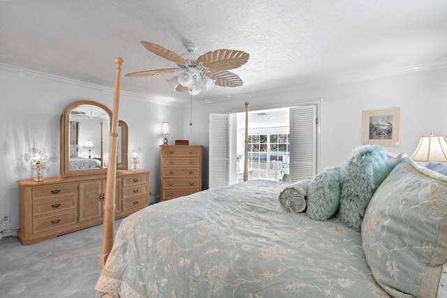 carpeted bedroom featuring ceiling fan, ornamental molding, and a textured ceiling