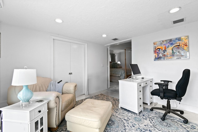 office area with a textured ceiling