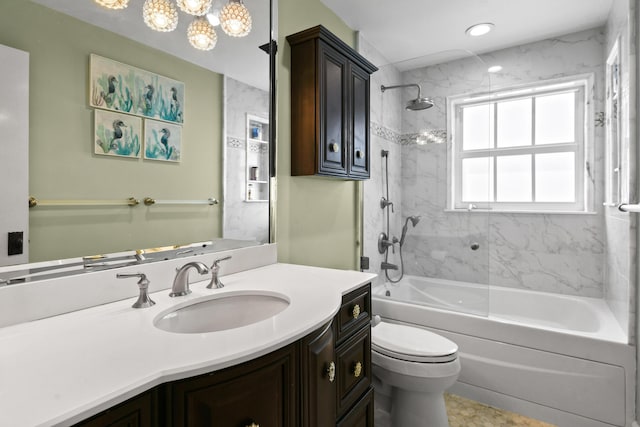 full bathroom featuring vanity, toilet, and tiled shower / bath