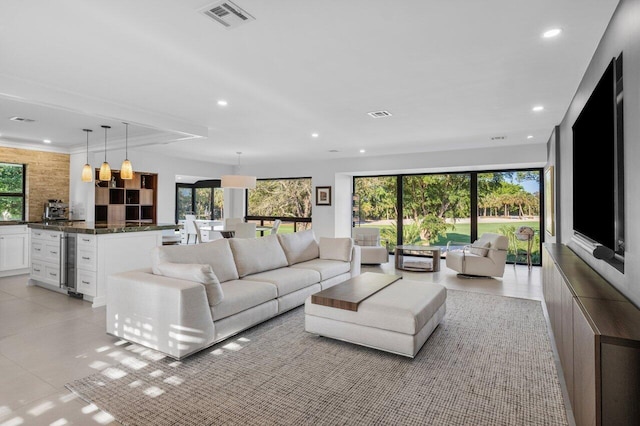 living room with plenty of natural light, visible vents, and recessed lighting