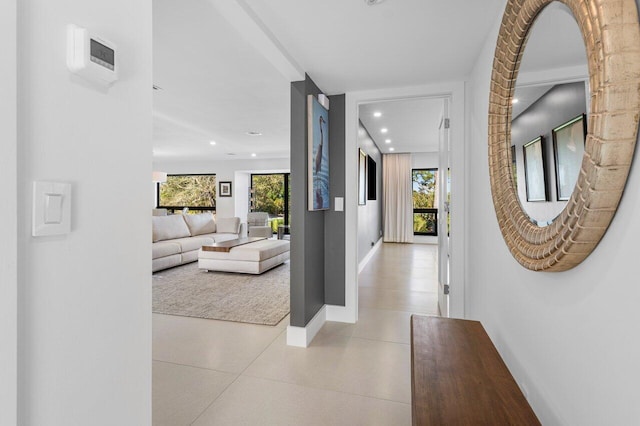 hallway with recessed lighting and baseboards