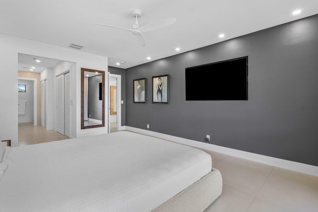 bedroom featuring light tile patterned floors, recessed lighting, visible vents, baseboards, and ensuite bath