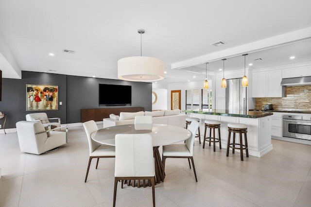 dining room featuring baseboards, visible vents, and recessed lighting