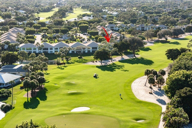 drone / aerial view featuring view of golf course and a residential view