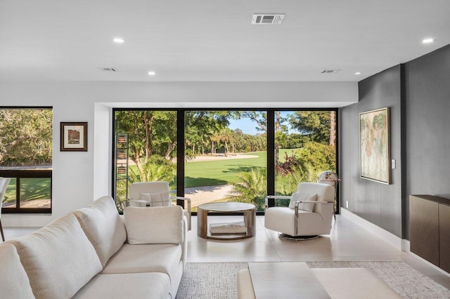 tiled living room featuring recessed lighting, visible vents, plenty of natural light, and baseboards