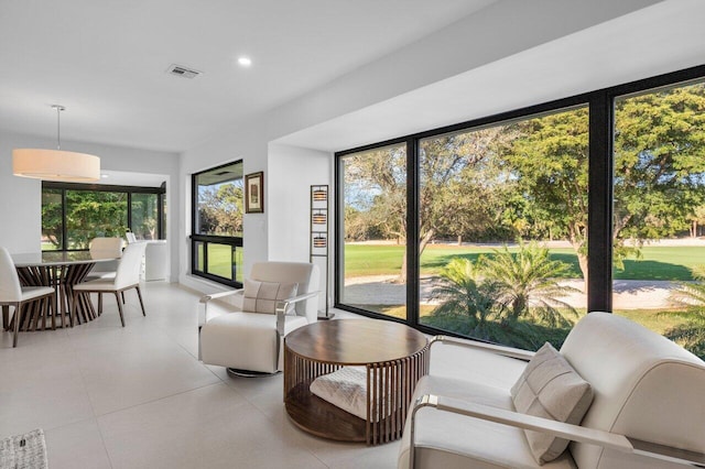 interior space with a sunroom, tile patterned flooring, and visible vents