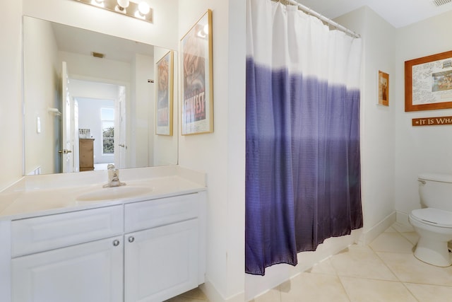 bathroom featuring vanity, tile patterned floors, and toilet