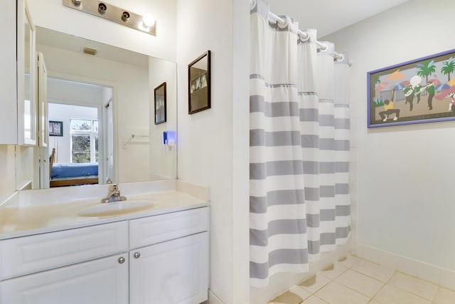 bathroom featuring tile patterned flooring, vanity, and shower / bath combo