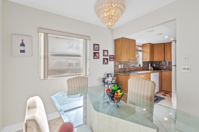 tiled dining space with a notable chandelier