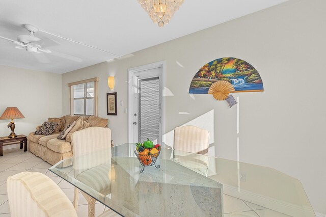 dining space with an inviting chandelier and light tile patterned floors