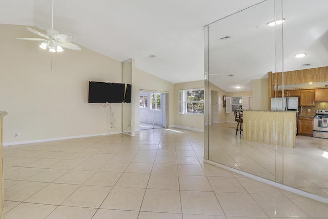 unfurnished living room with high vaulted ceiling, ceiling fan, and light tile patterned flooring