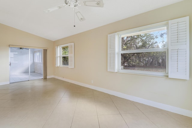 tiled spare room featuring lofted ceiling and ceiling fan