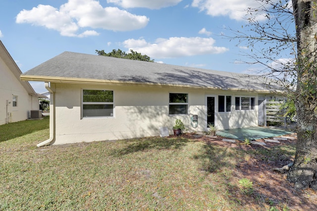 back of house with a yard, a patio area, and central air condition unit