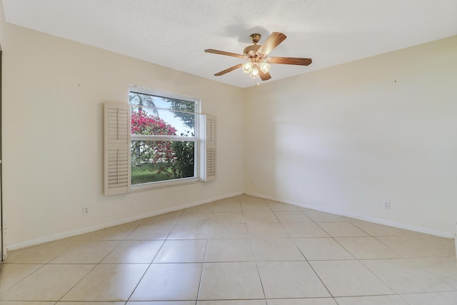 tiled empty room featuring a textured ceiling and ceiling fan