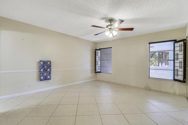 tiled empty room with a textured ceiling and ceiling fan