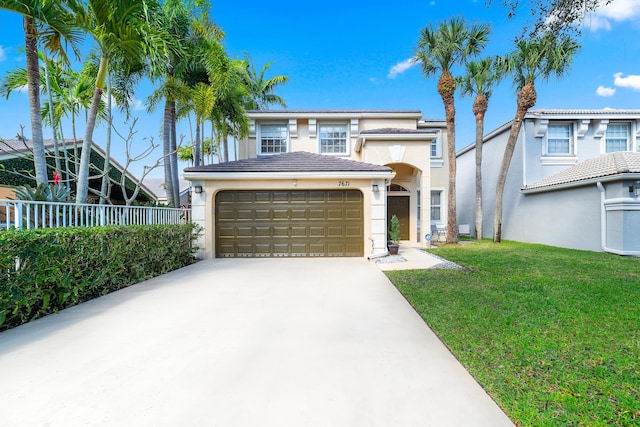 view of front of property featuring a garage and a front lawn