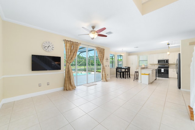 unfurnished living room with light tile patterned flooring, ceiling fan, and ornamental molding