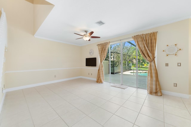 tiled empty room with crown molding and ceiling fan