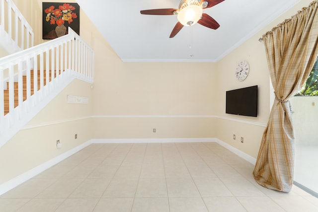 unfurnished living room with light tile patterned floors, ornamental molding, and ceiling fan