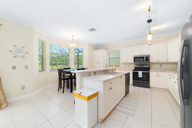 kitchen with sink, crown molding, hanging light fixtures, a kitchen island with sink, and black appliances