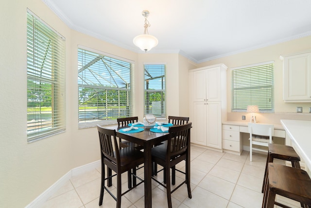 tiled dining space with ornamental molding, built in desk, and plenty of natural light