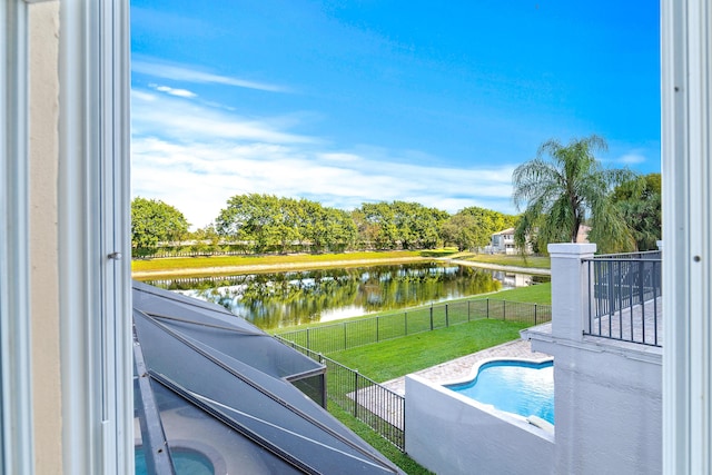 view of swimming pool with a water view and a yard