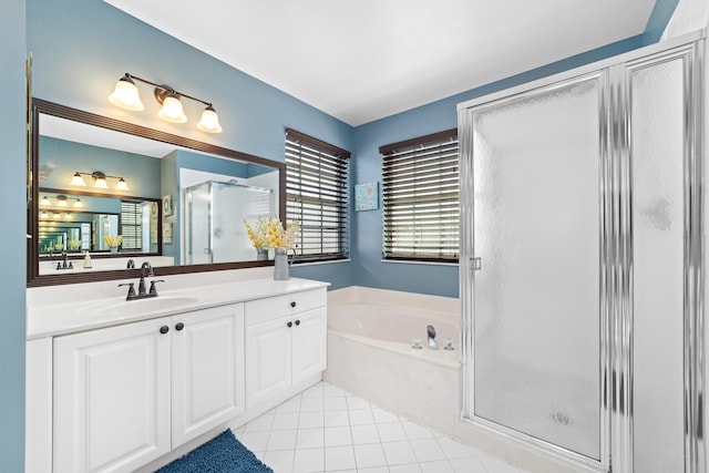 bathroom with shower with separate bathtub, vanity, and tile patterned floors