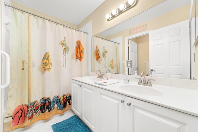 bathroom featuring tile patterned flooring, vanity, and walk in shower