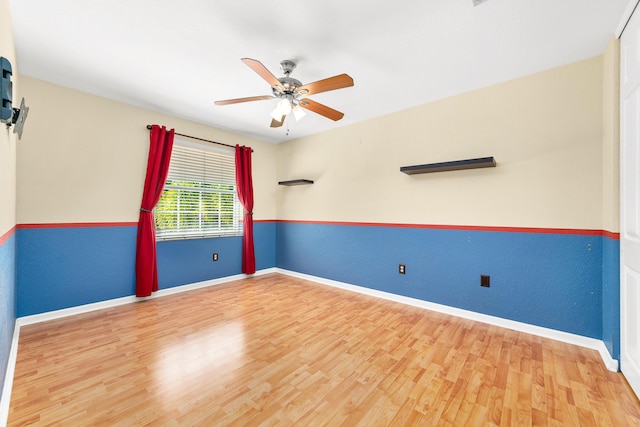 spare room with hardwood / wood-style flooring and ceiling fan