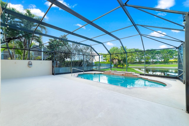 view of swimming pool with a water view, glass enclosure, and a patio area