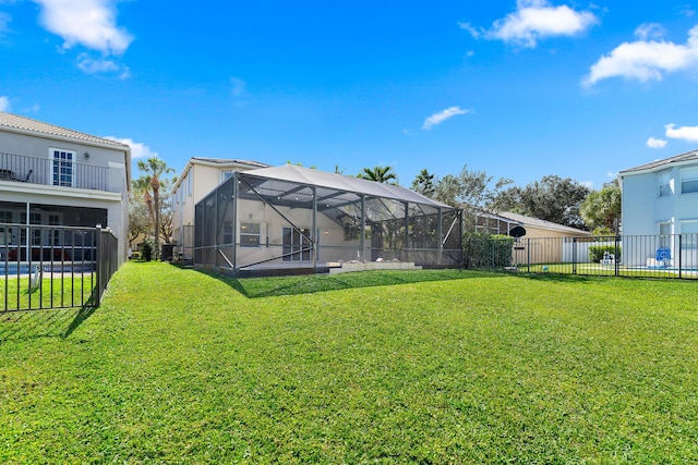 back of property with a yard and a lanai